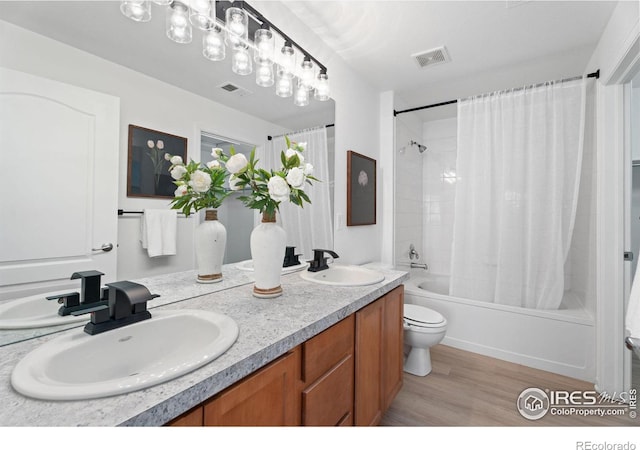 full bathroom featuring shower / tub combo with curtain, vanity, toilet, and hardwood / wood-style floors