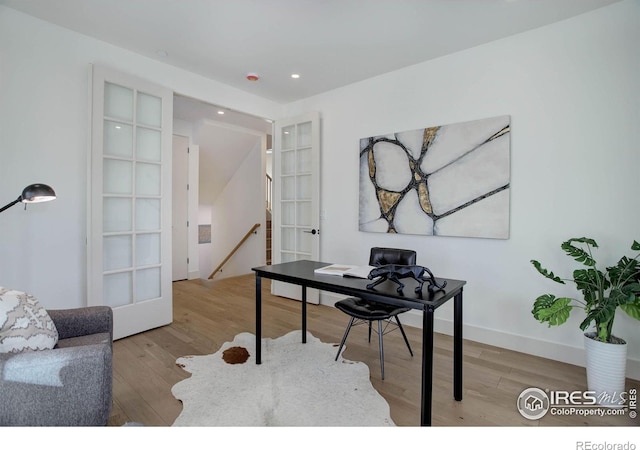 home office featuring french doors and light hardwood / wood-style flooring