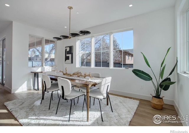 dining room featuring an inviting chandelier and light wood-type flooring