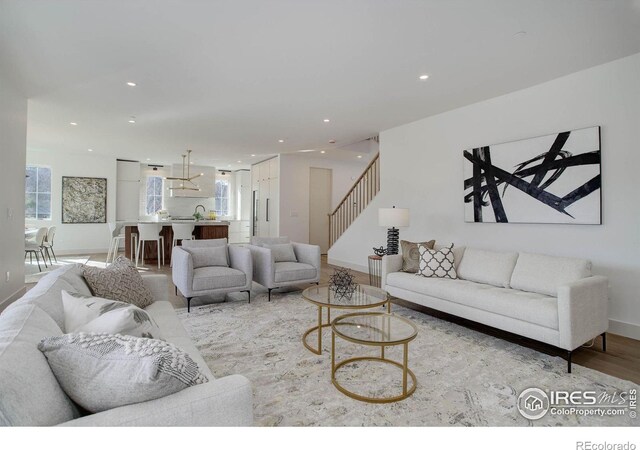 living room with a healthy amount of sunlight and light hardwood / wood-style flooring