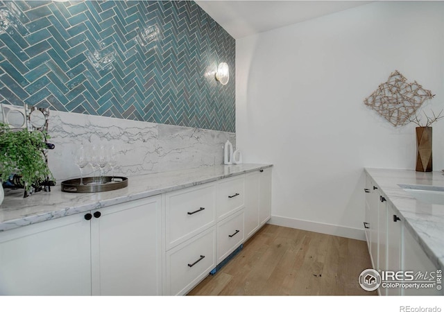 bathroom featuring vanity, hardwood / wood-style floors, and decorative backsplash