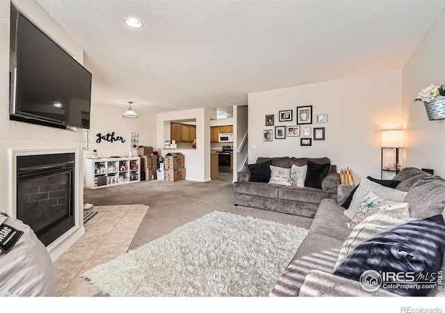 living room with light carpet and a textured ceiling