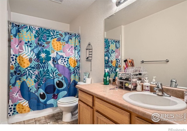 full bathroom featuring vanity, shower / tub combo, a textured ceiling, and toilet