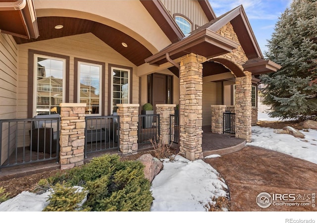 view of snow covered property entrance