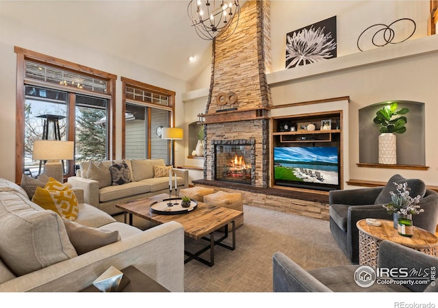 living room with an inviting chandelier, a fireplace, and high vaulted ceiling