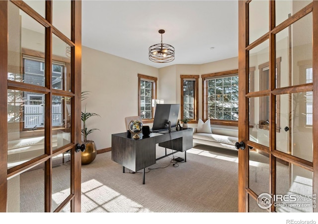 office area featuring a notable chandelier, light colored carpet, and french doors