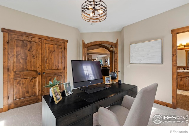 office featuring an inviting chandelier and light colored carpet