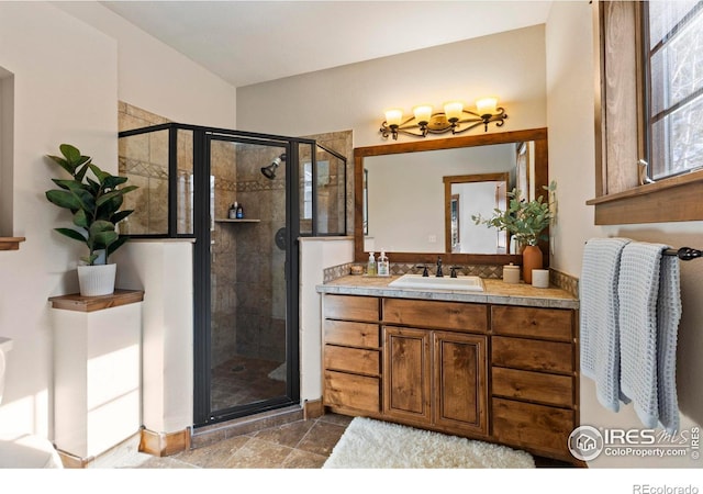 bathroom featuring vanity and a shower with door