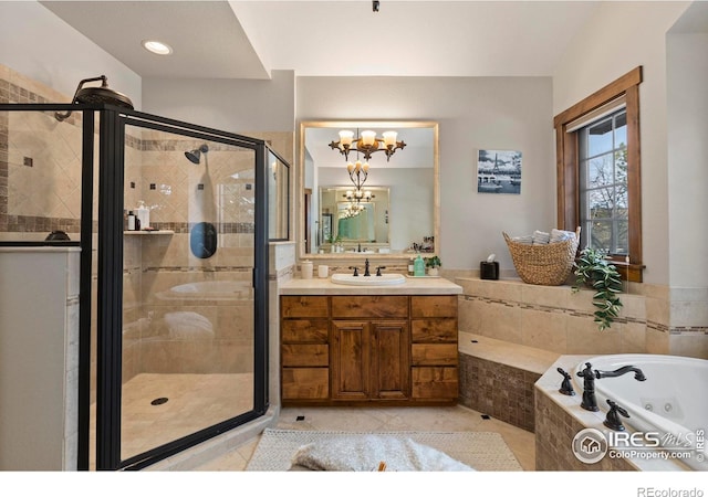 bathroom with an inviting chandelier, vanity, plus walk in shower, and tile patterned flooring