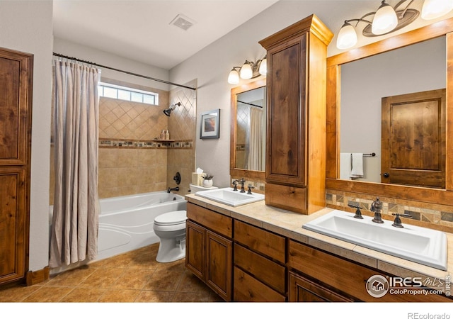 full bathroom featuring shower / bath combination with curtain, tile patterned floors, vanity, and toilet