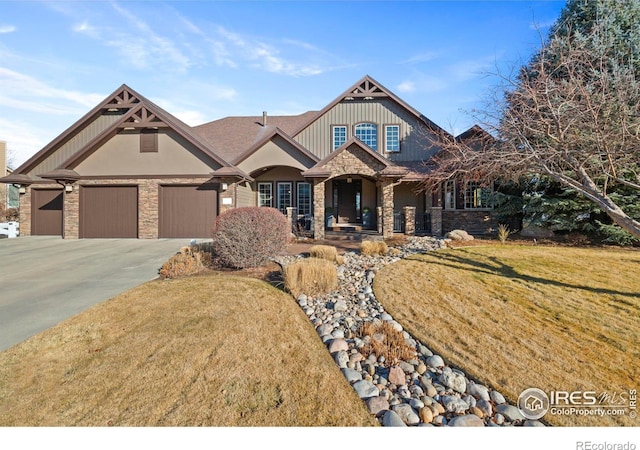 craftsman-style home featuring a garage and a front lawn