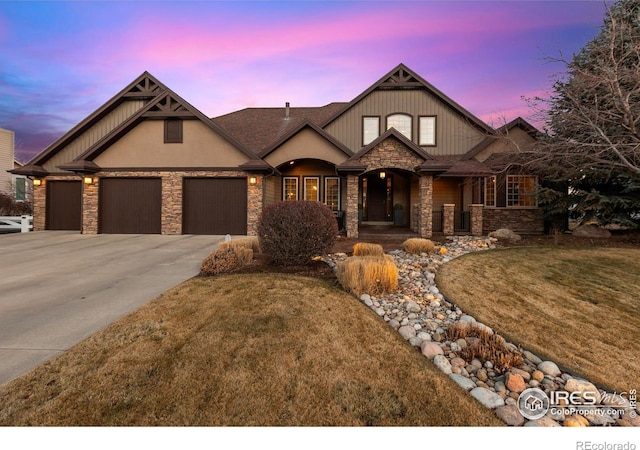 craftsman inspired home with a garage and a lawn