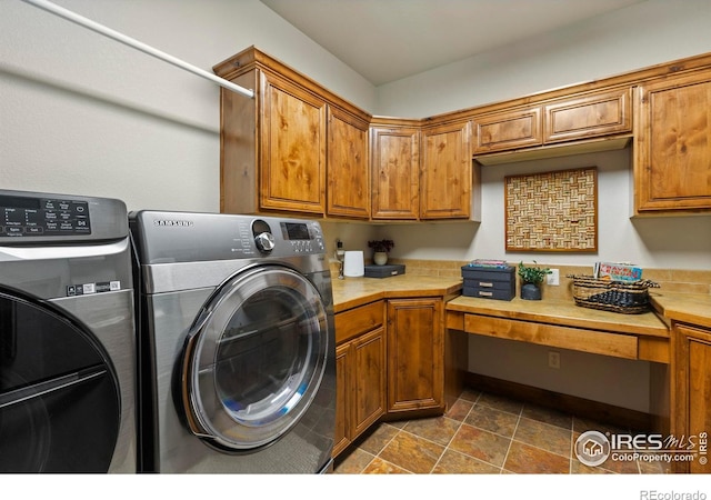 clothes washing area with cabinets and washer and dryer