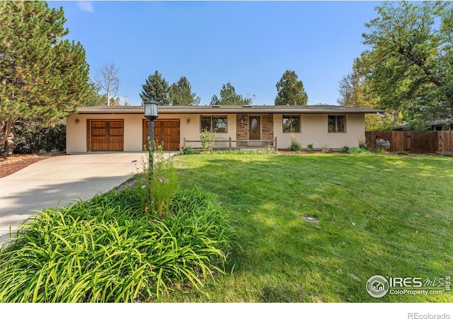 ranch-style house featuring a garage and a front yard