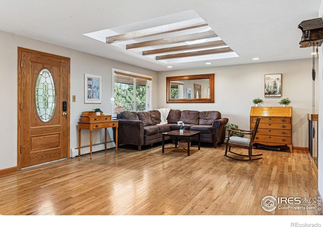 living room with baseboard heating, beam ceiling, and light hardwood / wood-style floors