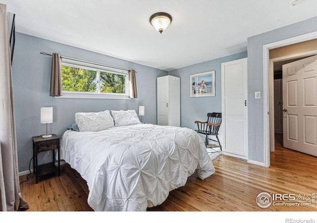 bedroom with wood-type flooring