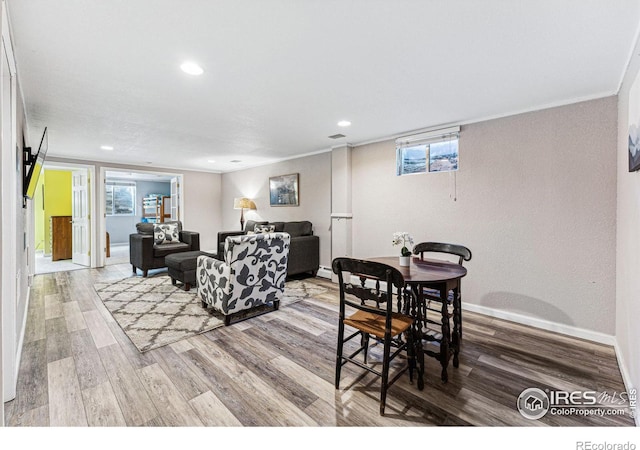 living room with hardwood / wood-style flooring and ornamental molding