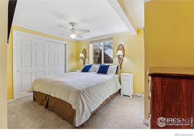 carpeted bedroom featuring ceiling fan and a closet