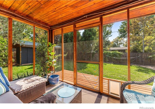 sunroom featuring wood ceiling