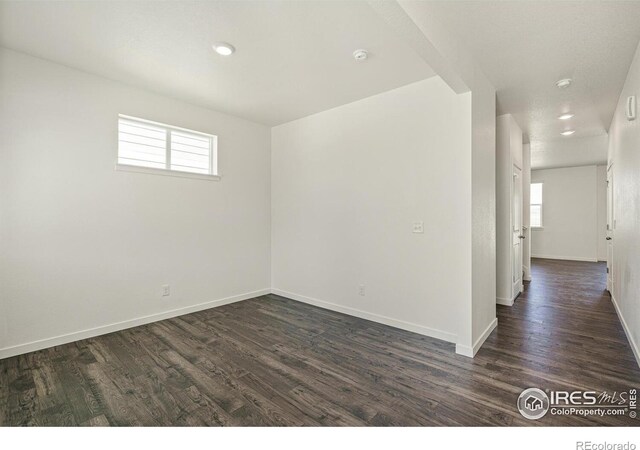 unfurnished room with dark hardwood / wood-style floors