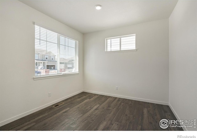 spare room with dark wood-type flooring