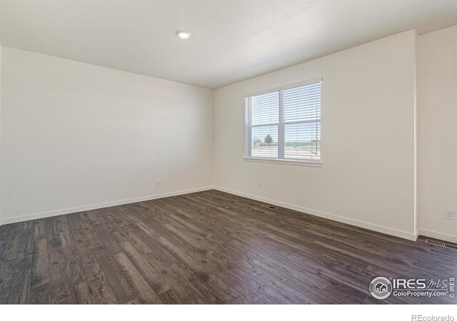 empty room featuring dark hardwood / wood-style floors