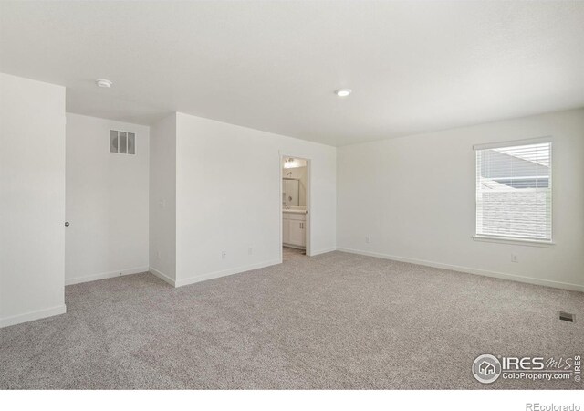 unfurnished room featuring light colored carpet