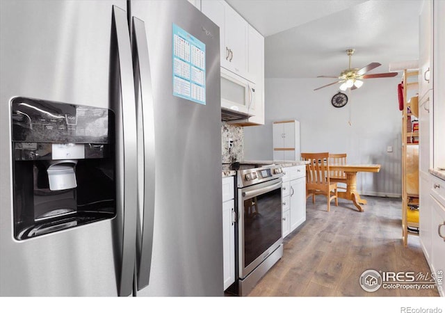 kitchen with decorative backsplash, wood-type flooring, stainless steel appliances, and white cabinets