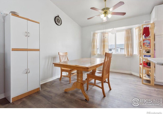 dining area with wood-type flooring, lofted ceiling, and ceiling fan