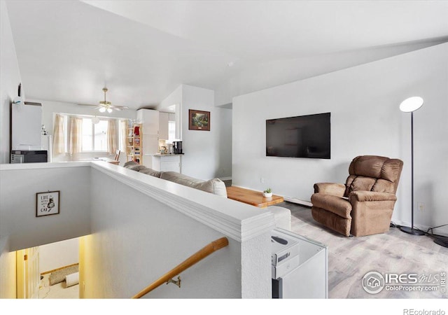 living room featuring vaulted ceiling and light wood-type flooring