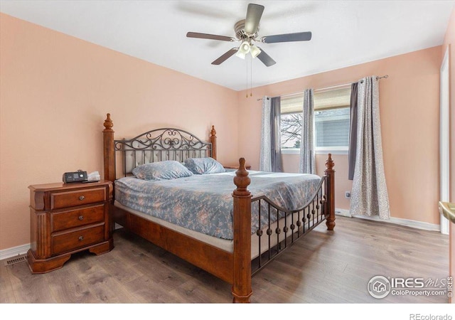 bedroom featuring hardwood / wood-style floors and ceiling fan