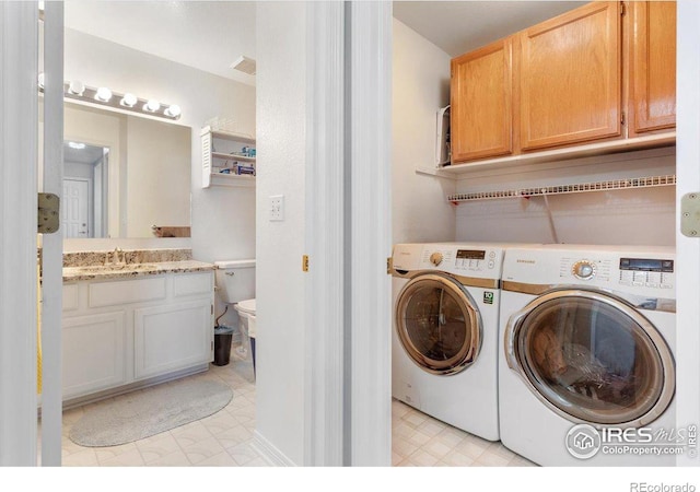 laundry area with sink and washing machine and clothes dryer