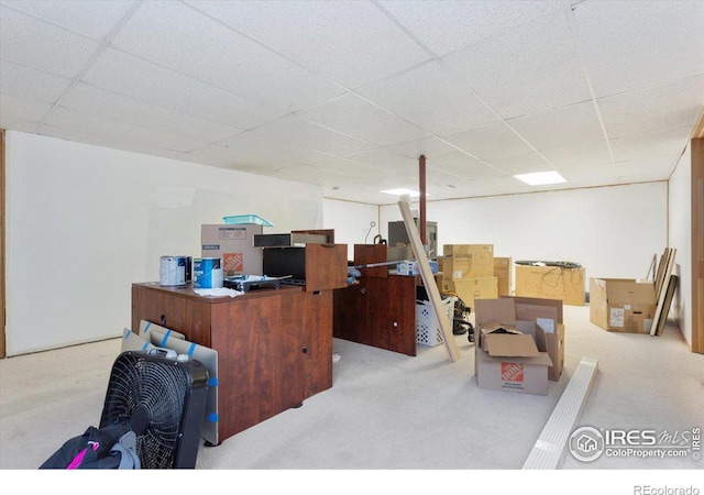 carpeted office space with a paneled ceiling