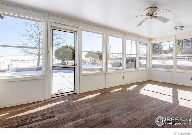 unfurnished sunroom featuring a wealth of natural light and ceiling fan