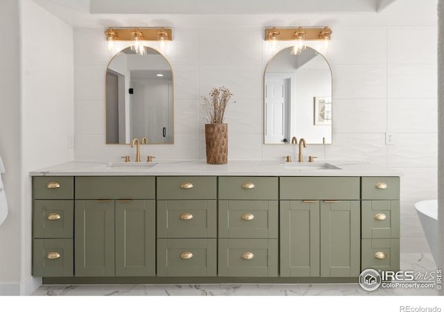 bathroom with double vanity, tile walls, and a sink