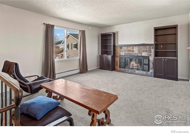 carpeted living room with a fireplace, a baseboard radiator, and a textured ceiling