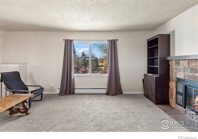 living area with baseboard heating, a stone fireplace, carpet floors, and a textured ceiling