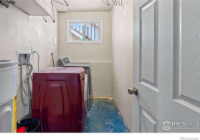 laundry area with separate washer and dryer and electric water heater