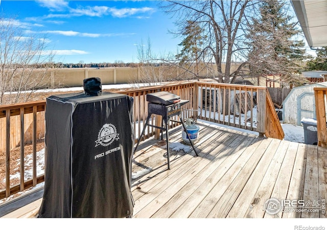 snow covered deck featuring grilling area