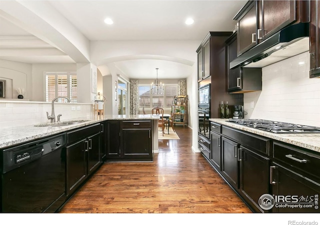 kitchen featuring dishwasher, sink, hanging light fixtures, stainless steel gas cooktop, and light stone counters