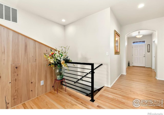 corridor with hardwood / wood-style flooring