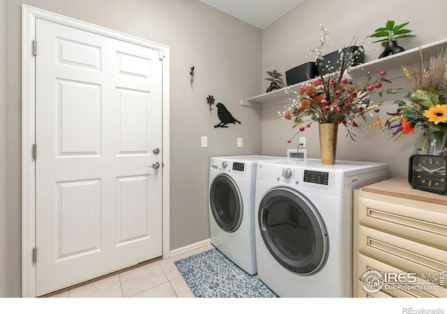 washroom with light tile patterned floors and independent washer and dryer