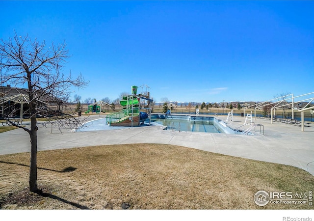 view of swimming pool featuring a playground