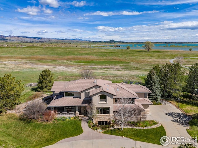 birds eye view of property with a water and mountain view