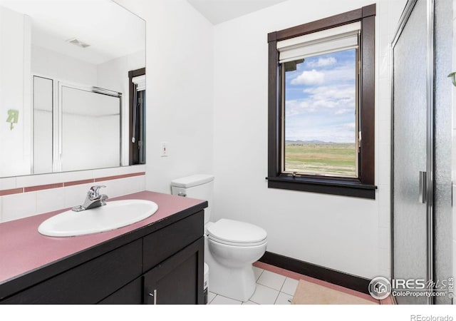 bathroom with an enclosed shower, vanity, tile patterned floors, and toilet