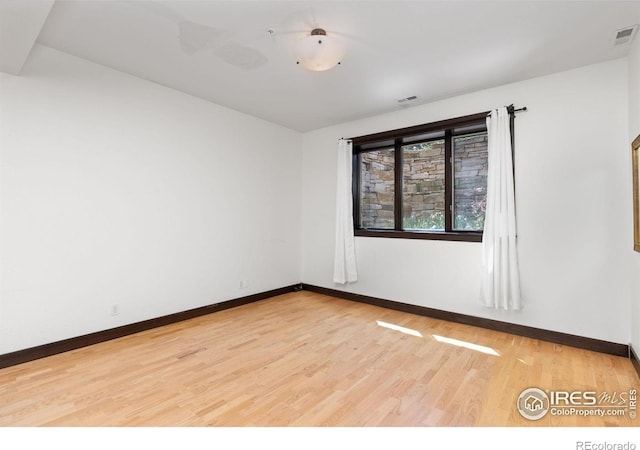 spare room featuring hardwood / wood-style flooring