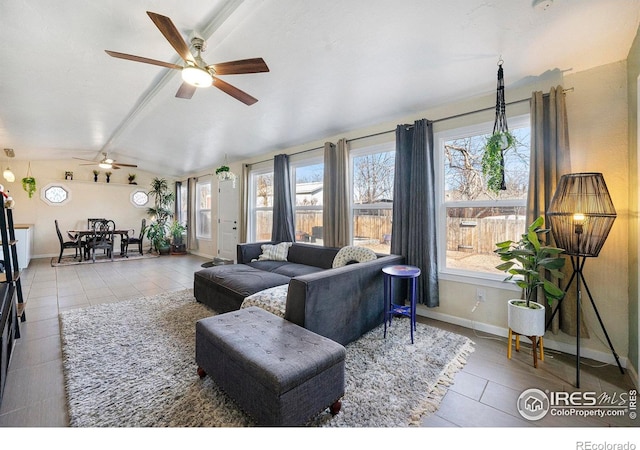 living room featuring ceiling fan and vaulted ceiling with beams