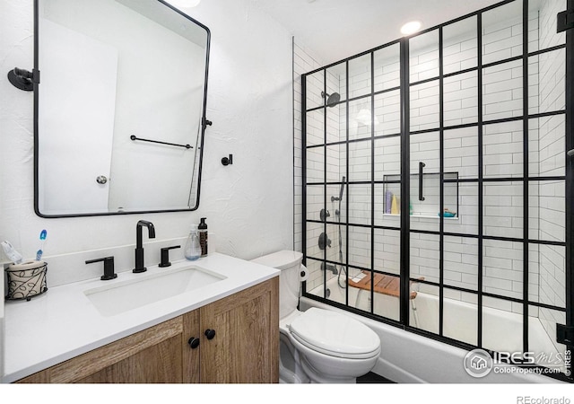 full bathroom featuring vanity, shower / bath combination with glass door, and toilet