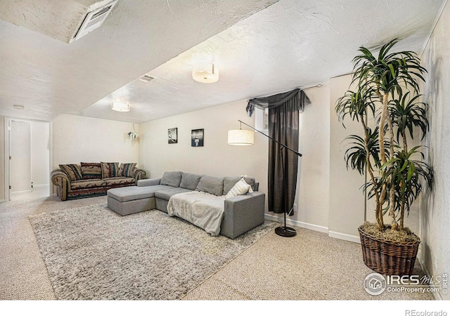 carpeted living room featuring a textured ceiling