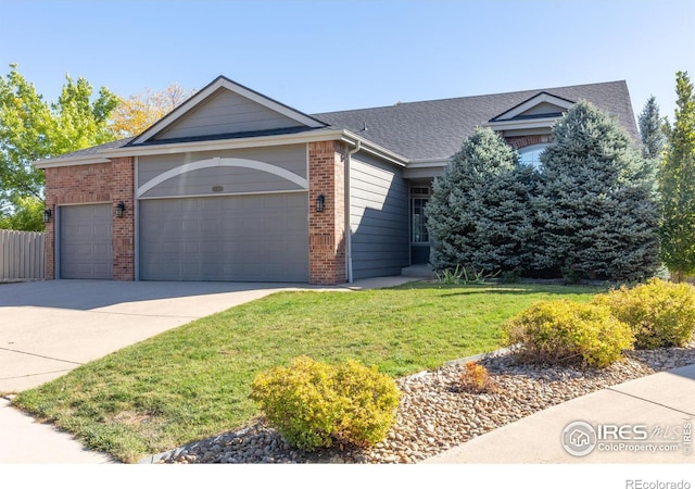 view of front facade with a garage and a front lawn